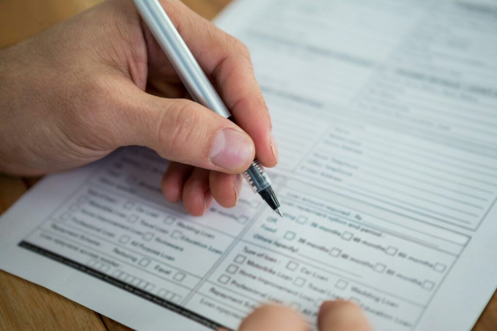 Businesswoman filling last will and testament form