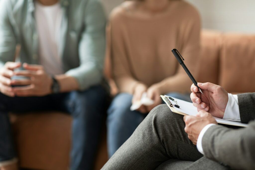Couple having therapy session with male professional
